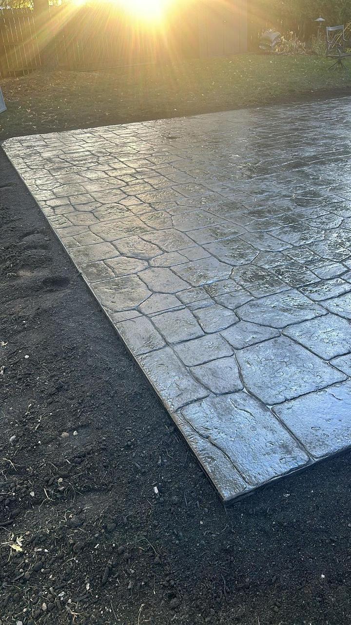 Ashlar stone stamped concrete patio at sunset
