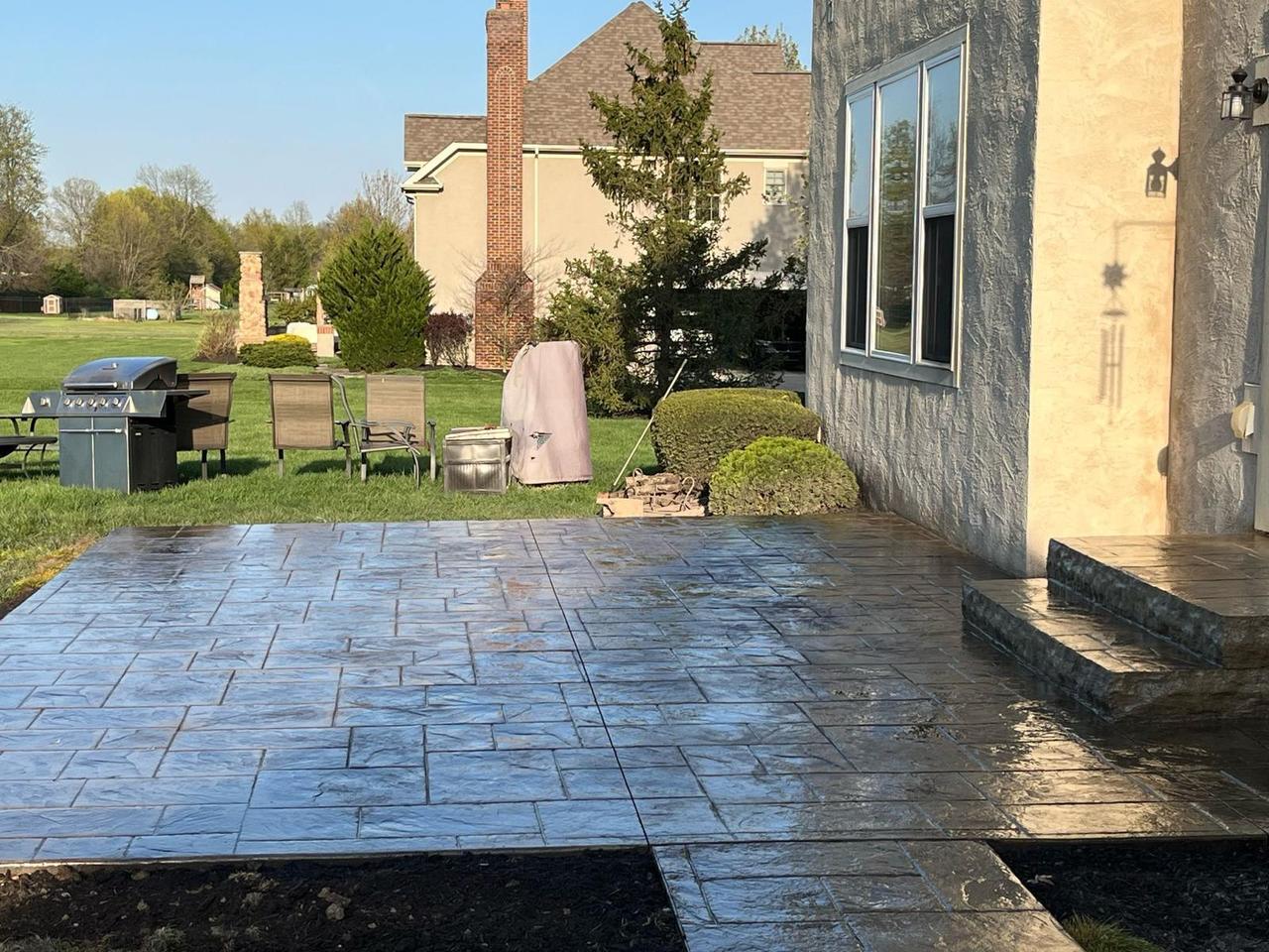 Stamped concrete patio with raised step-up landing