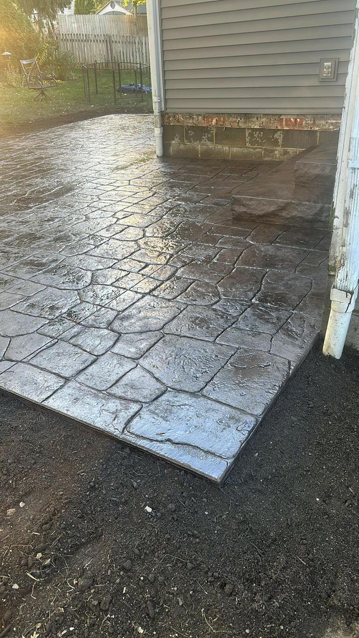 Cobblestone pattern stamped concrete patio with fresh sealer