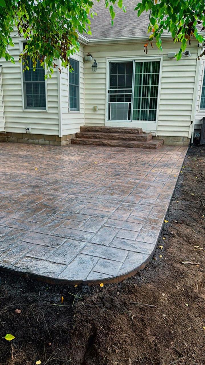 Stamped concrete patio with curved freeform edge and steps