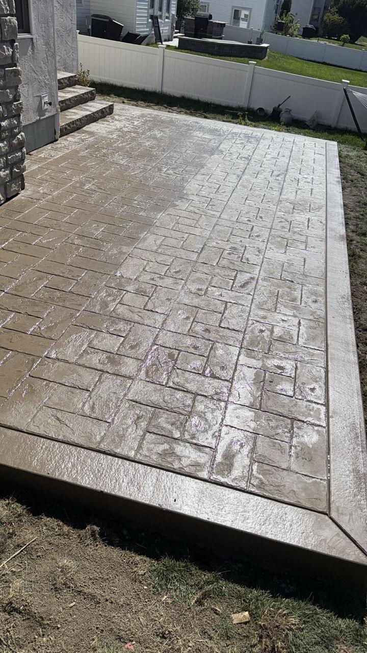 Herringbone brick stamped concrete patio with smooth border