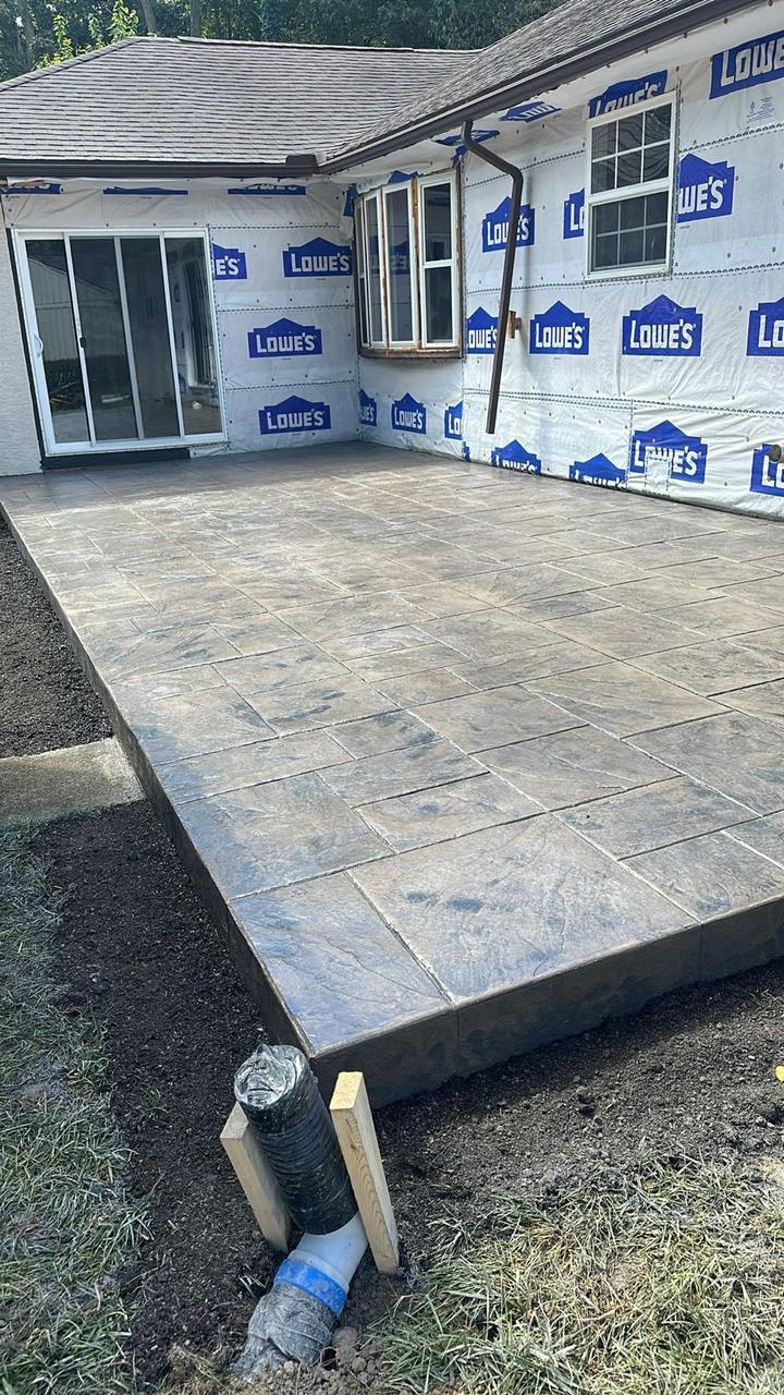 Ashlar slate stamped concrete patio with sliding door access