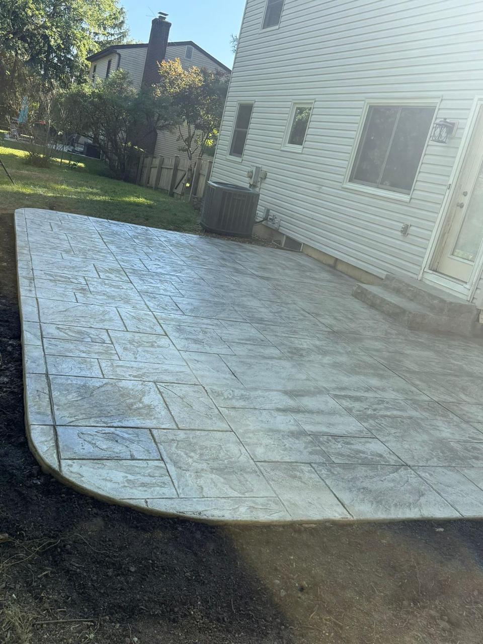 Large light ashlar stamped concrete patio