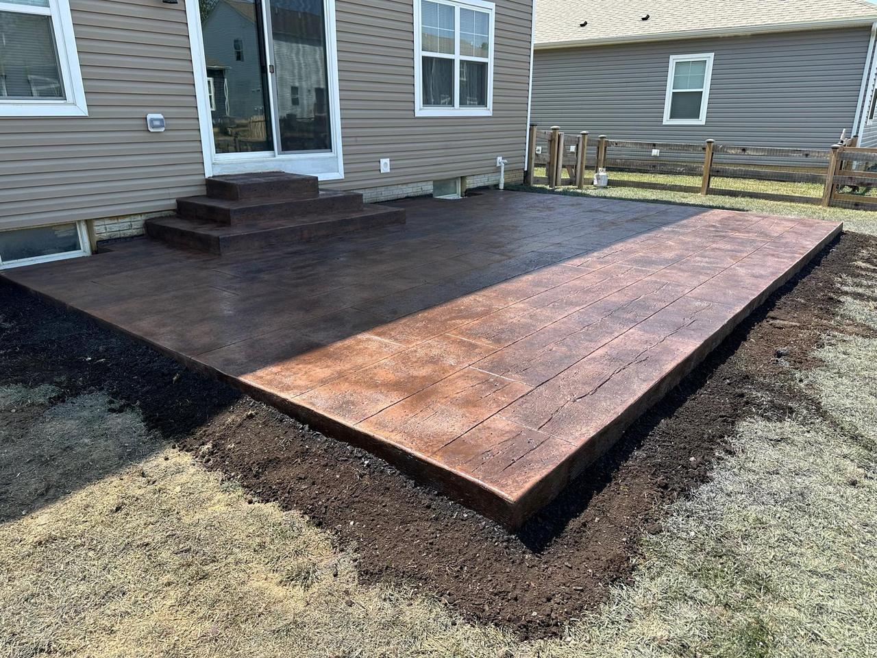 Wood plank stamped concrete patio with contrasting border