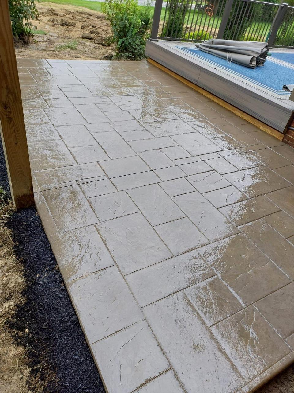 Grey stamped concrete pool deck with rounded corner detail
