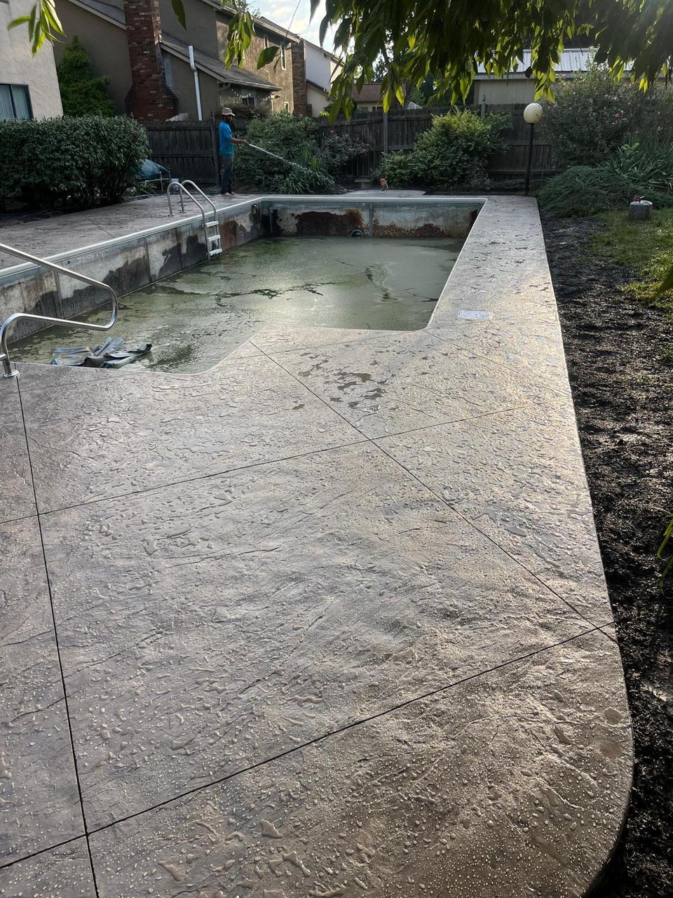 Wide stamped concrete pool deck surround
